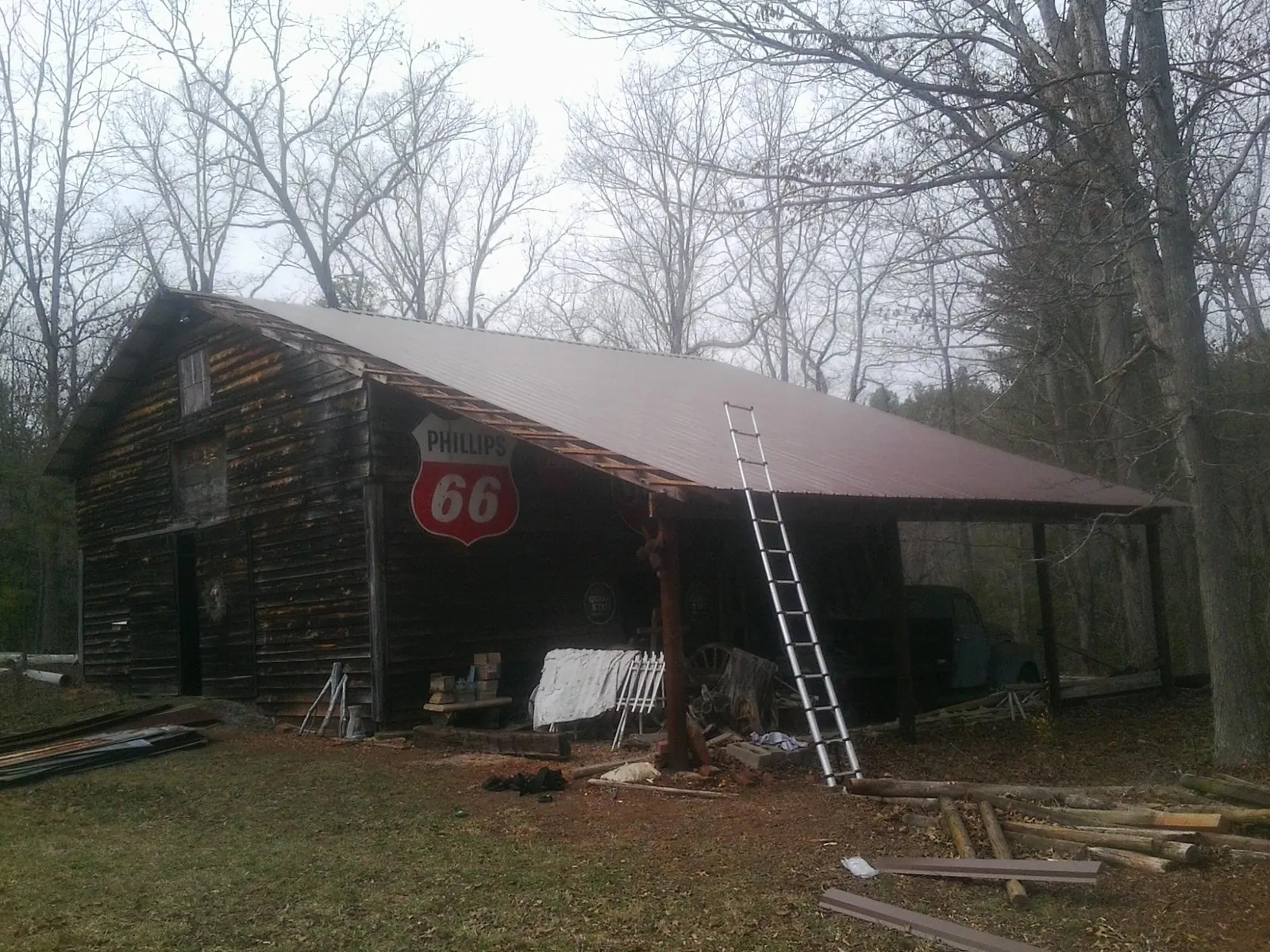 New metal roof on an open sided timber barn with a vintage sign in Redfield