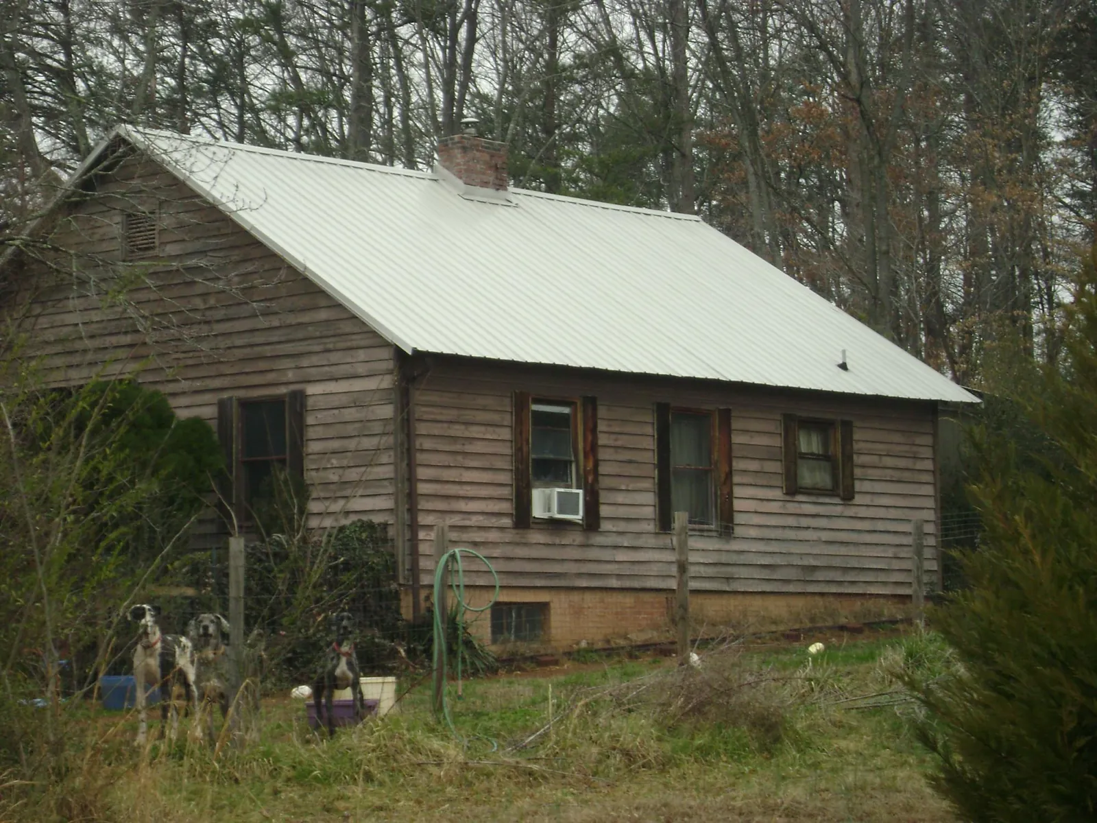 White metal roof on an old wood sided farmhouse, from a Metal Roof Installation job in Redfield